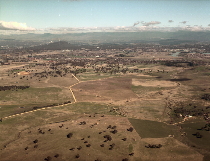Gungahlin in May 1986. Looking south-west along Gundaroo Road and Ginninderra Creek from above ‘Horse Park’ (now Jacka). (Source: 5313 - Office of Surveyor General Photos) Gungahlin in May 1986. Looking south-west along Gundaroo Road and Ginninderra Creek from above ‘Horse Park’ (now Jacka). (Source: 5313 - Office of Surveyor General Photos)