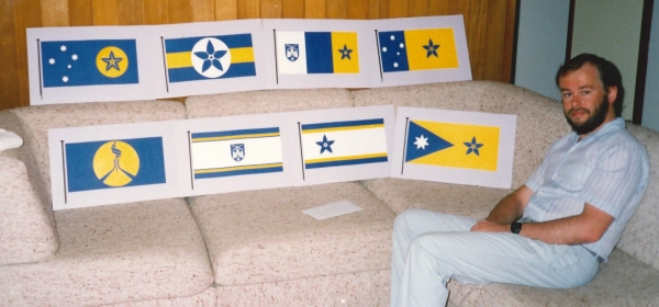 A photo of Ivo Ostyn with some of his flag designs in 1990. Record 89/18742.